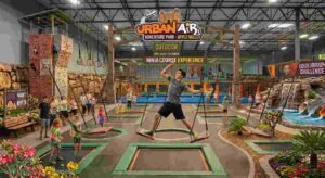 Urban Air Trampoline and Adventure Park: The Ultimate Family Fun Guide (2026) 2 Adolescent navigating an obstacle upon the Urban Air ninja course